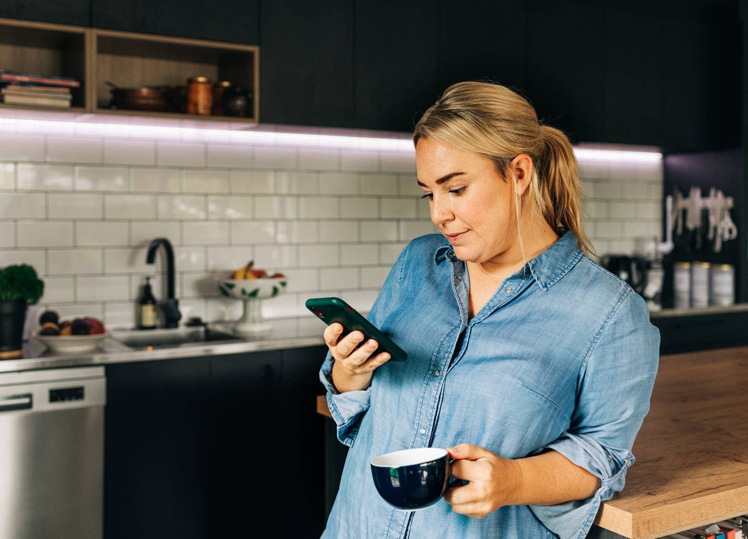 Woman using smartphone to find faucet repair professionals near Your Area on NearbyHunt