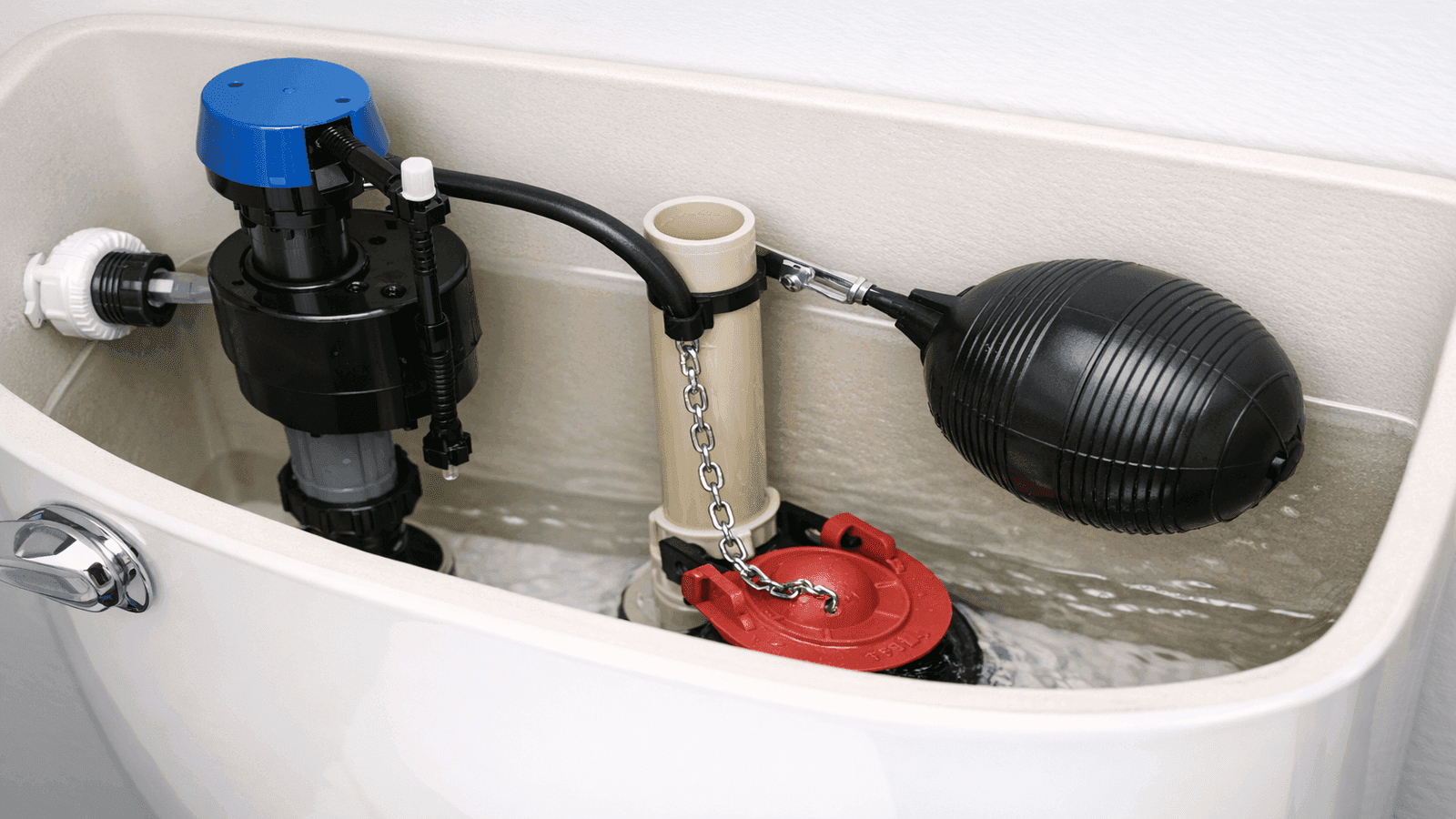 Toilet tank interior showing fill valve, flapper, and float mechanism