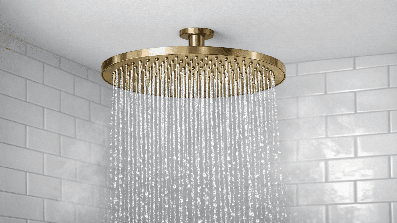 Brushed gold 12-inch ceiling-mounted rainfall showerhead with water cascading in a white subway tile shower