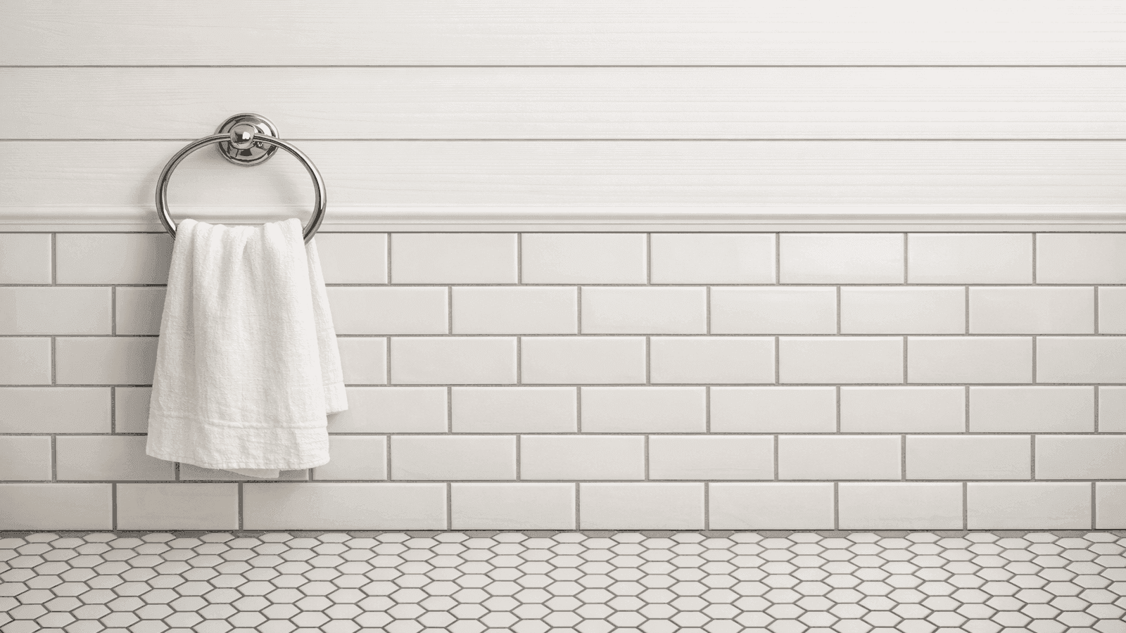 Farmhouse bathroom with white shiplap above subway tile wainscoting and white hex tile floor with gray grout