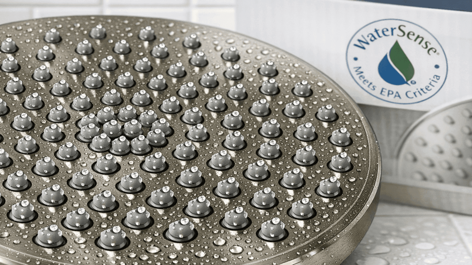 Close-up of WaterSense-certified rainfall showerhead with self-cleaning silicone nozzles in brushed nickel finish
