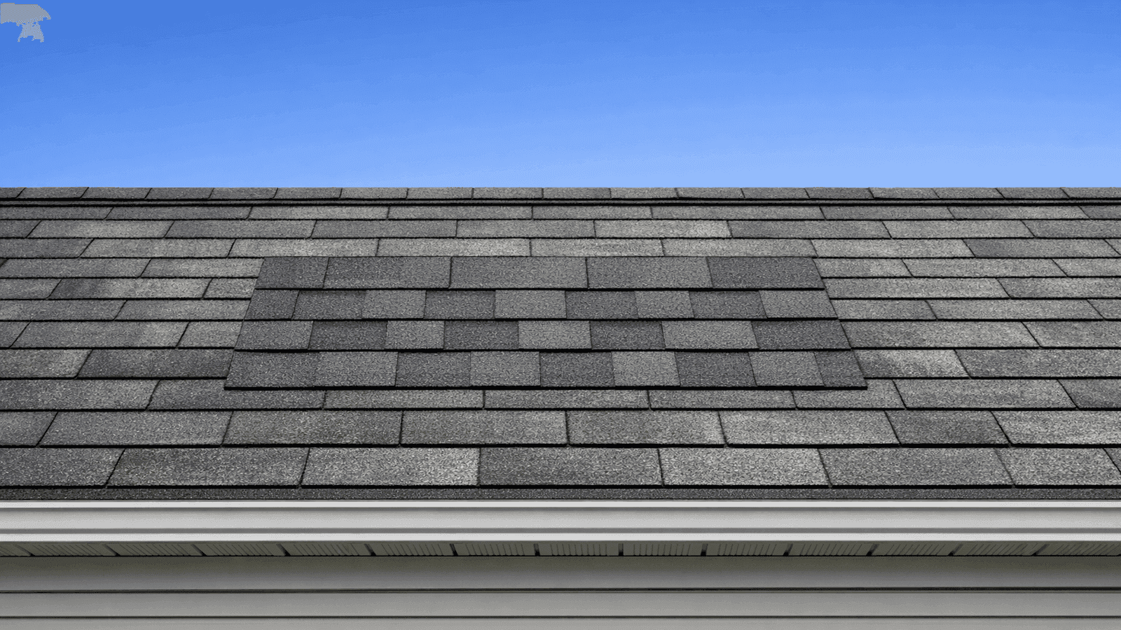 Ground-level view of a completed 8-shingle replacement repair on a low-slope residential garage roof showing proper course alignment, flat tab edges, and slight color variance between new and weathered surrounding shingles